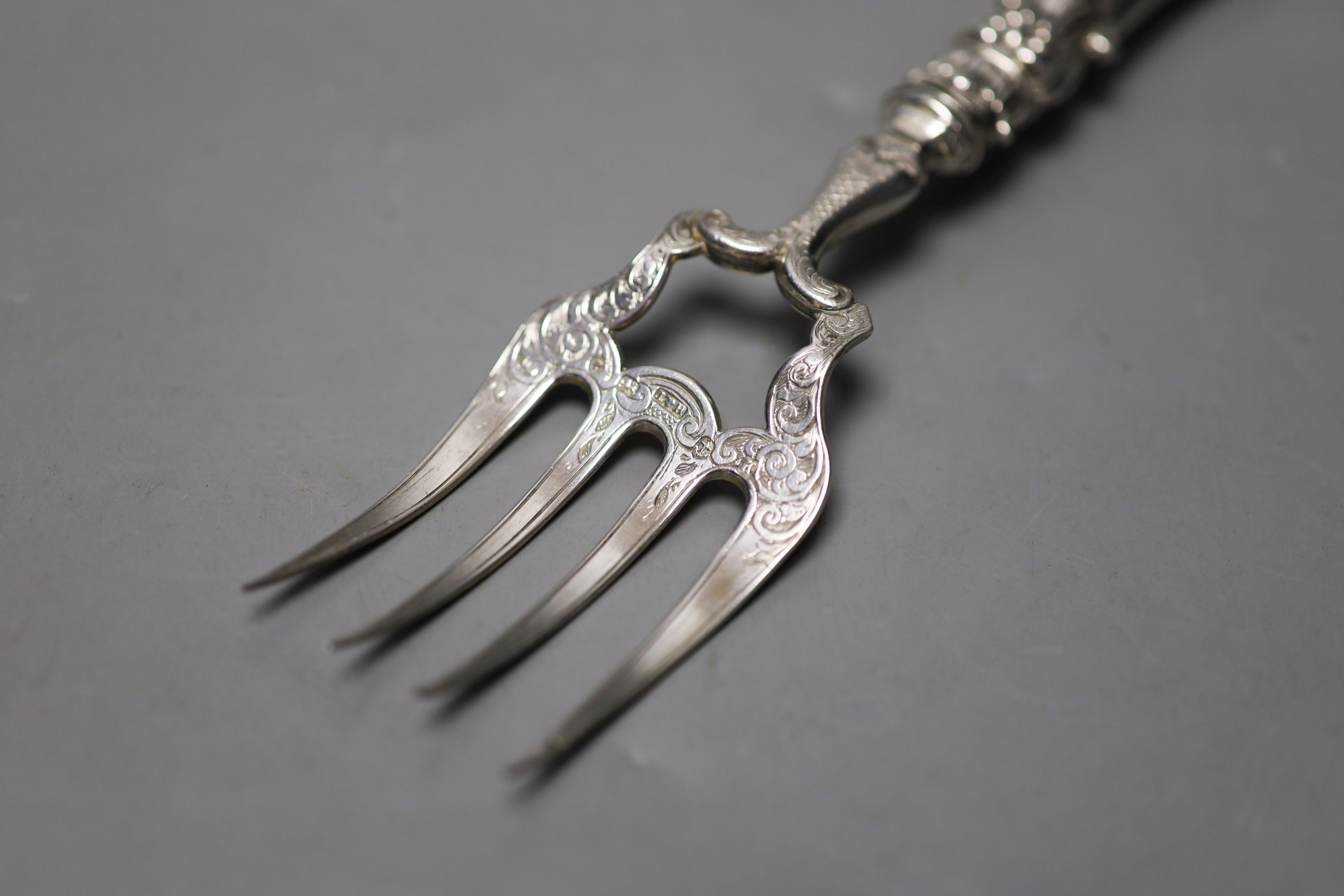 A pair of Victorian pierced silver fish servers, with loaded handles, Hilliard & Thomasson, Birmingham, 1859, knife 32cm.